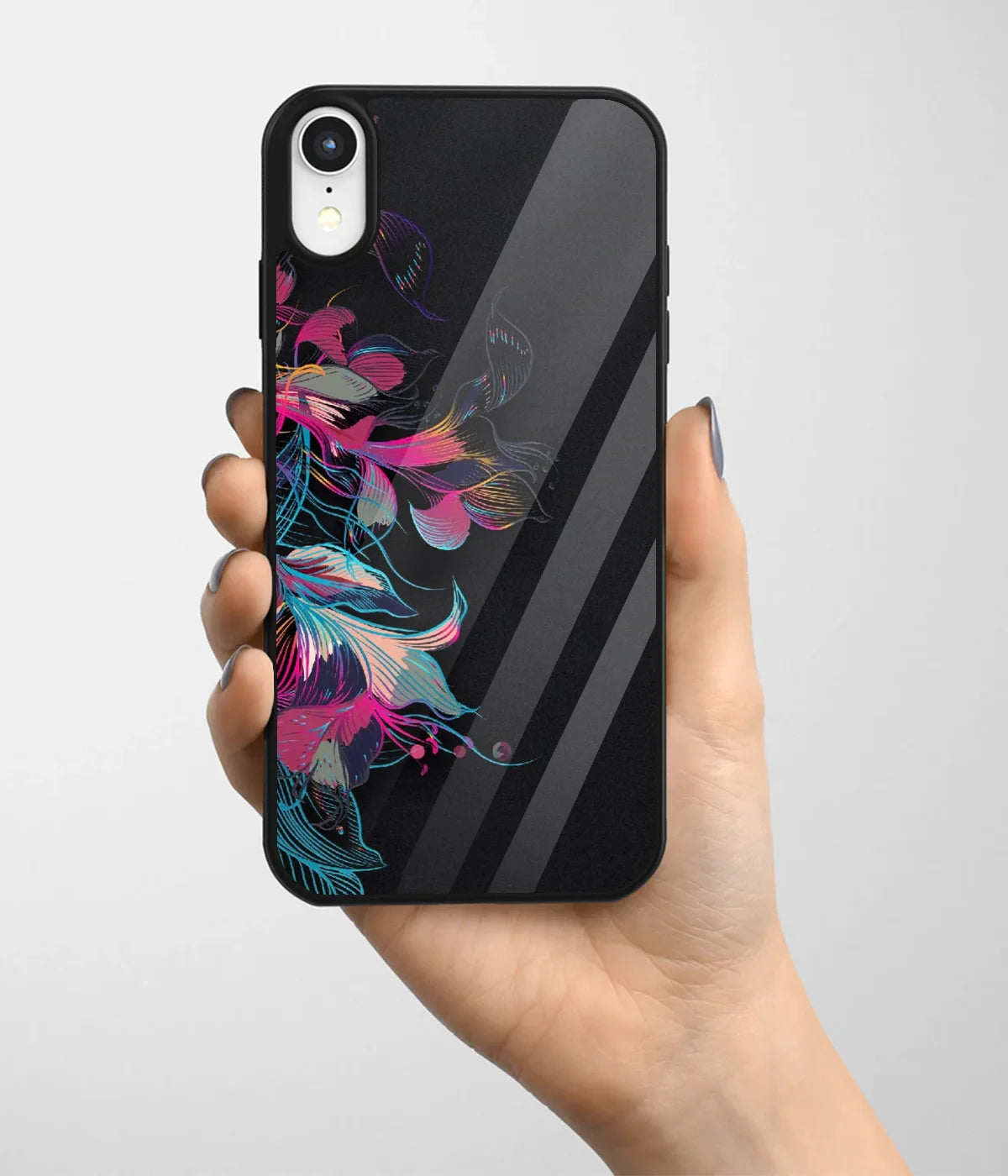 A hand holding a glass phone case with a colorful design.