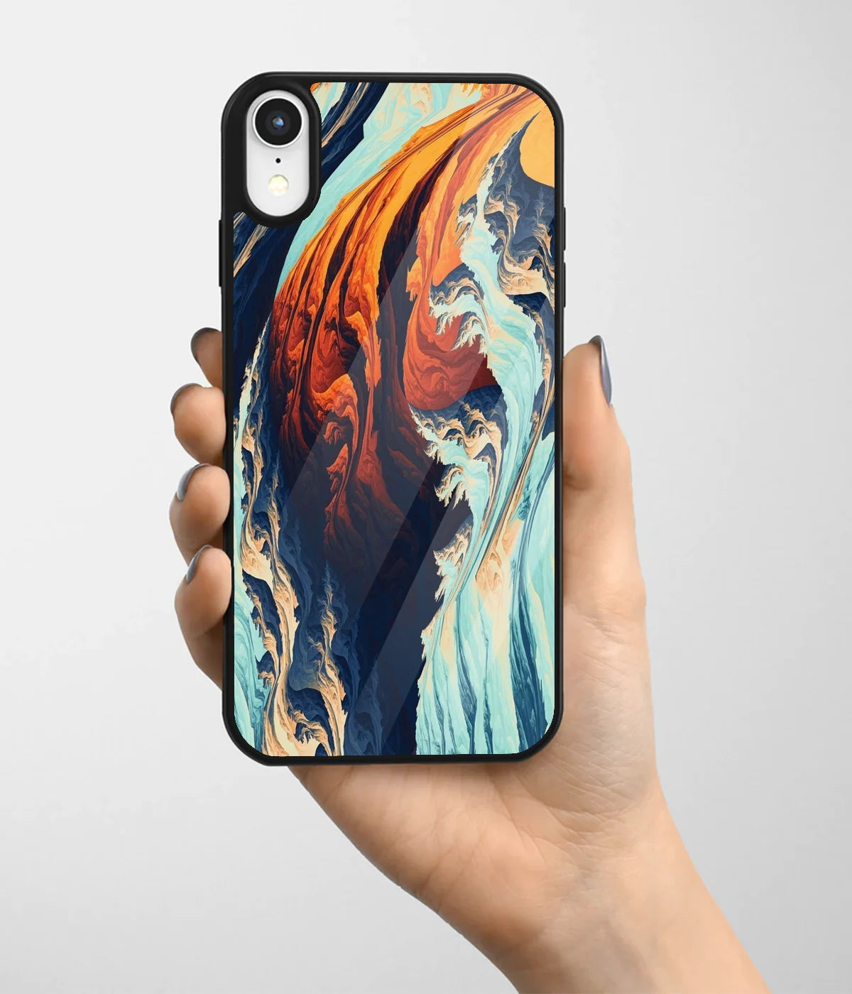 A hand holding a glass phone case with a colorful design.