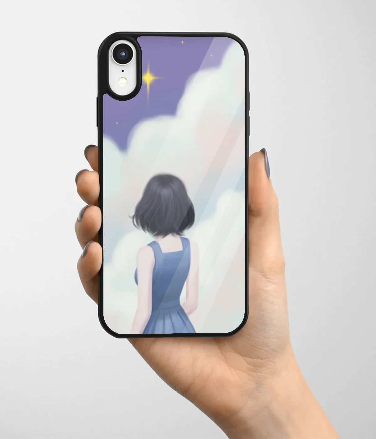 A hand holding a glass phone case with a colorful design.