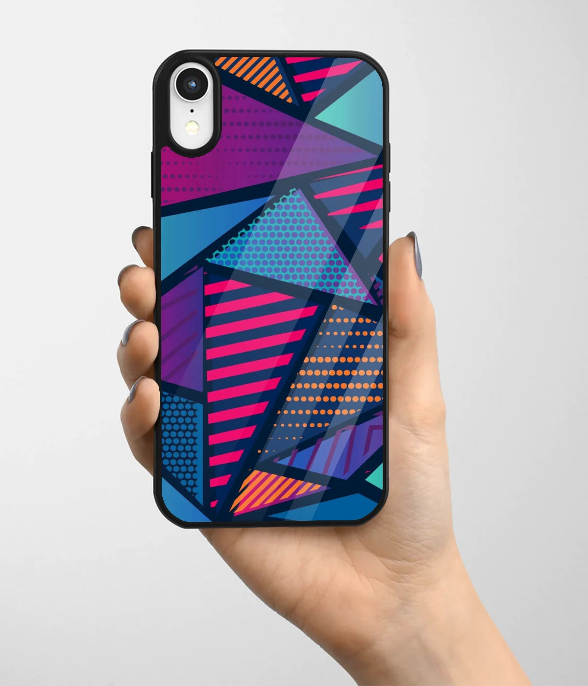 A hand holding a glass phone case with a colorful design.