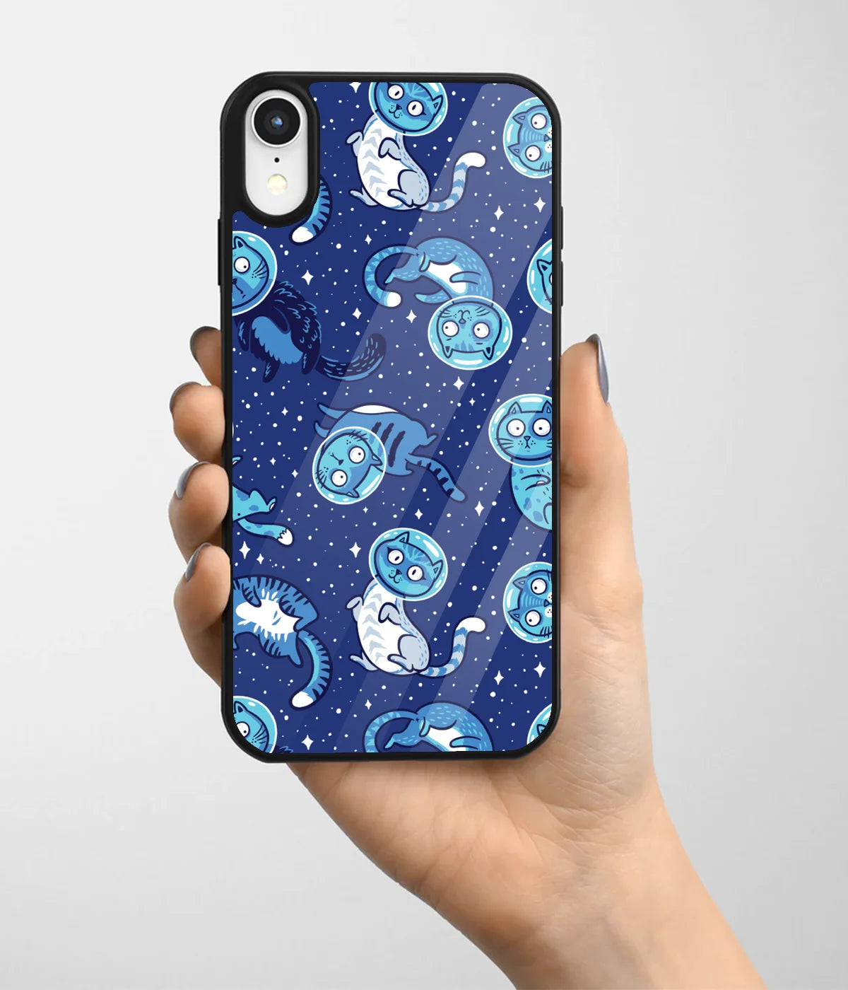 A hand holding a glass phone case with a colorful design.