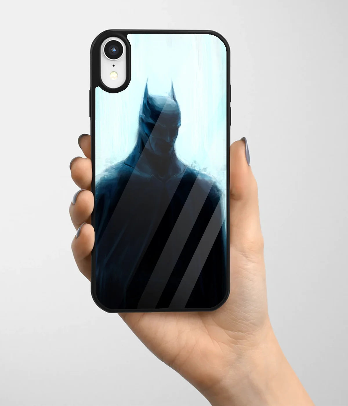 A hand holding a glass phone case with a colorful design.