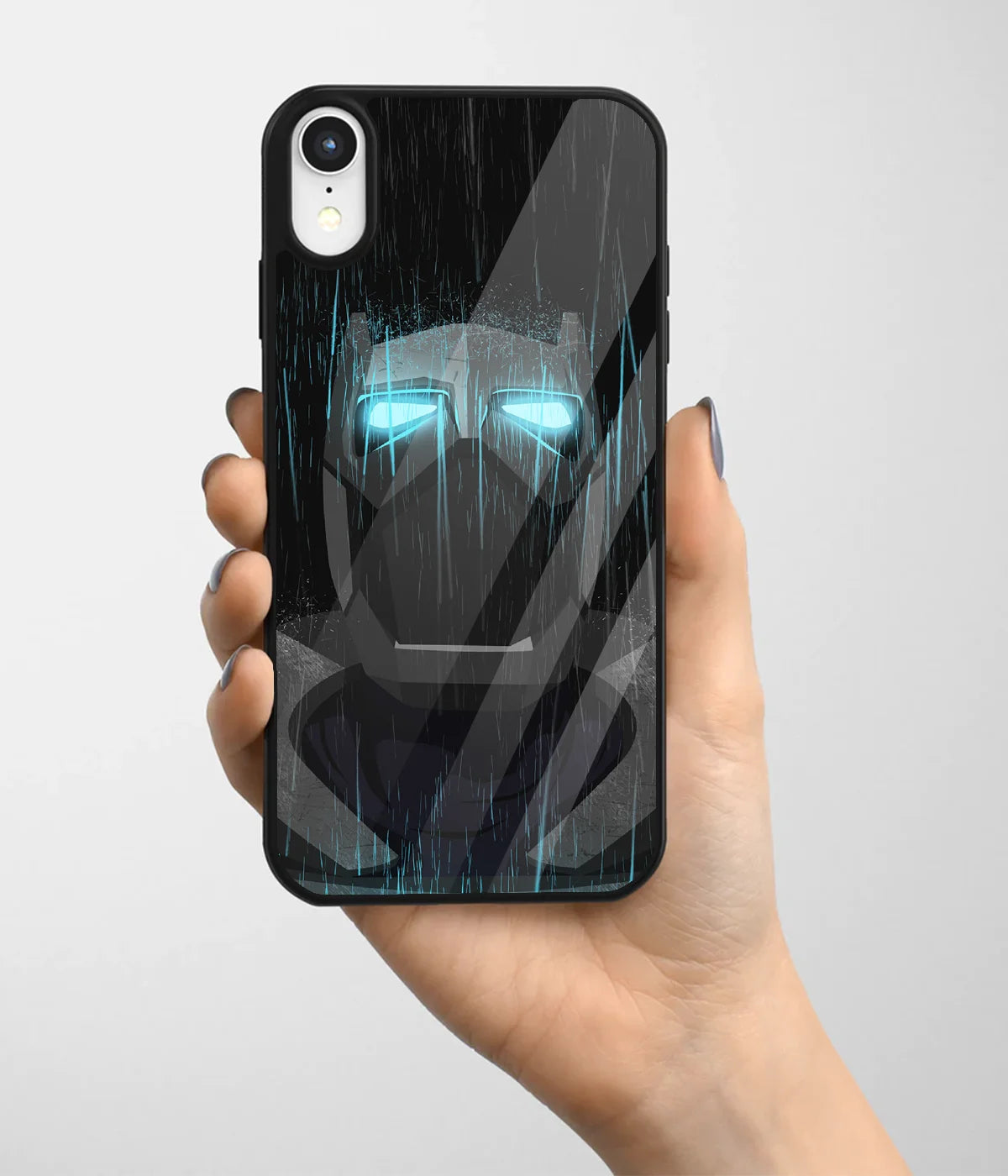 A hand holding a glass phone case with a colorful design.