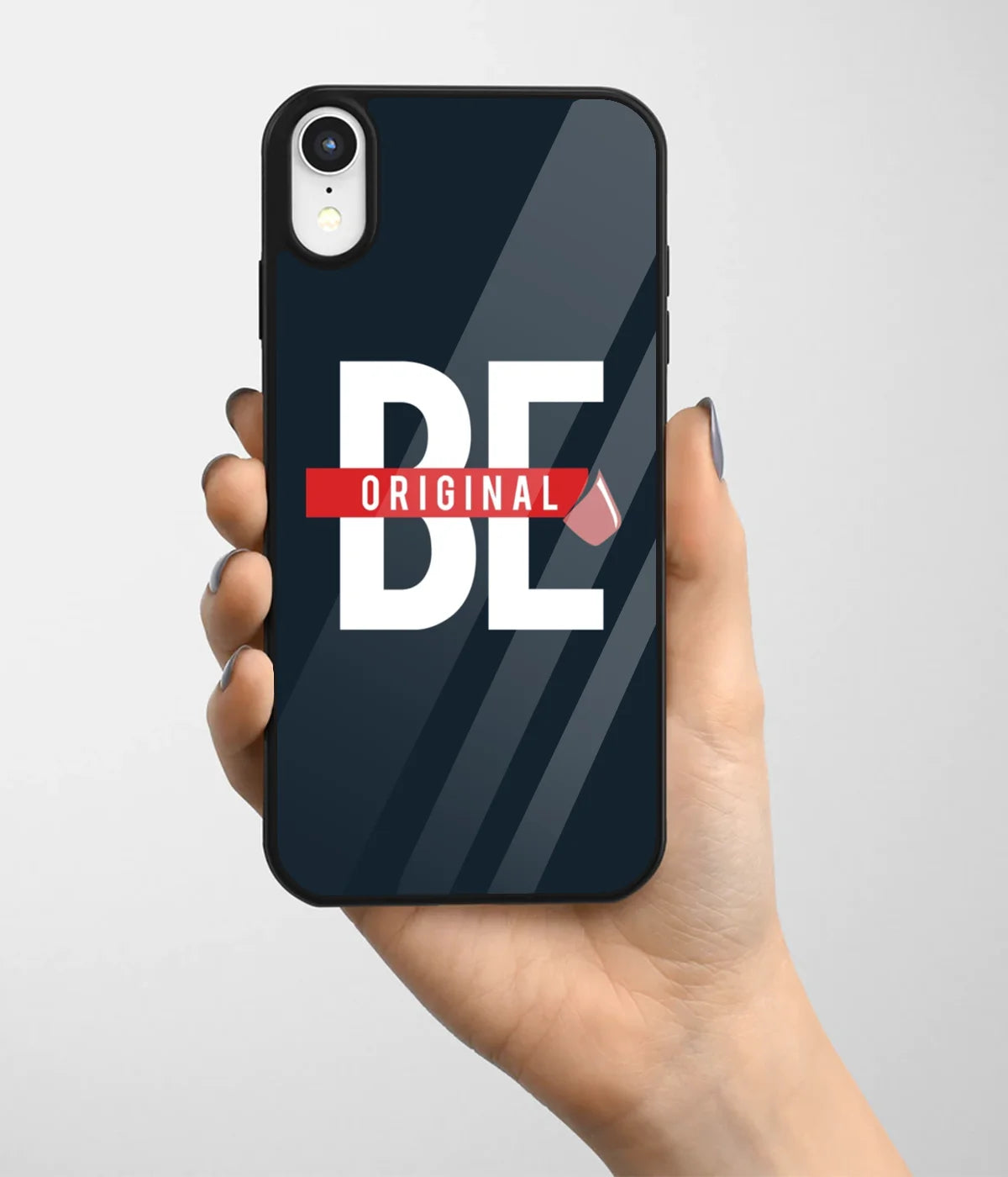A hand holding a glass phone case with a colorful design.