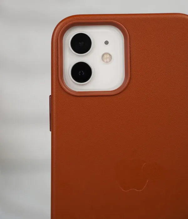 Close-up shot of the premium brown leather case for iPhone detailing raised protective lip around the iPhone camera module.