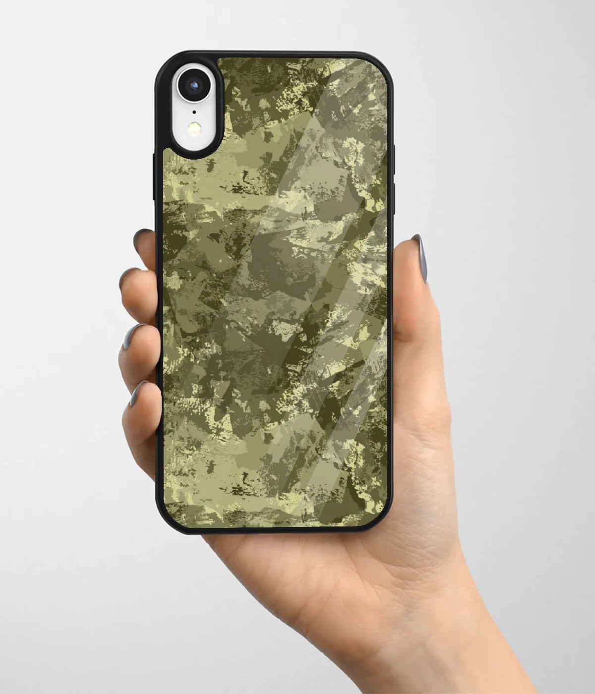 A hand holding a glass phone case with a colorful design.