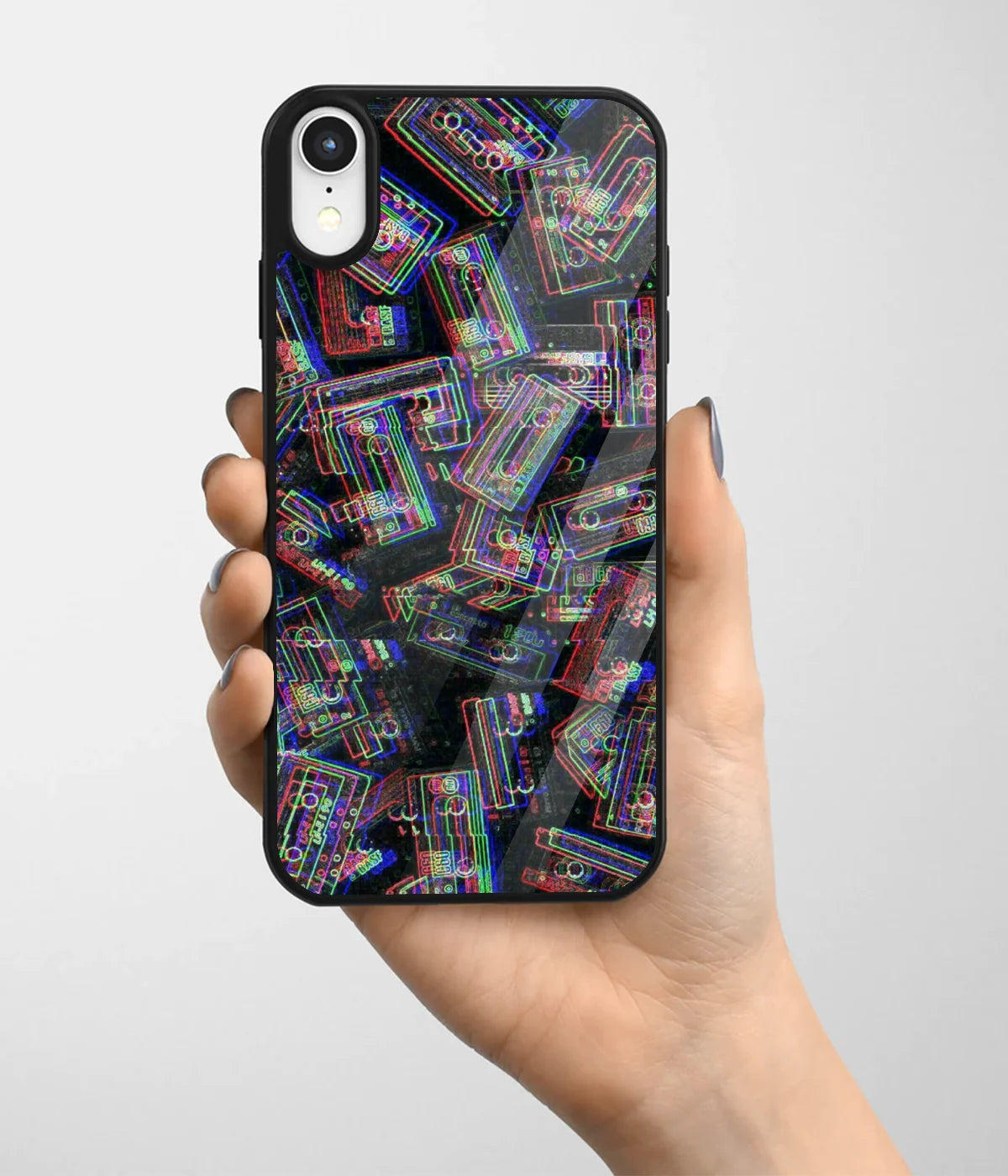 A hand holding a glass phone case with a colorful design.