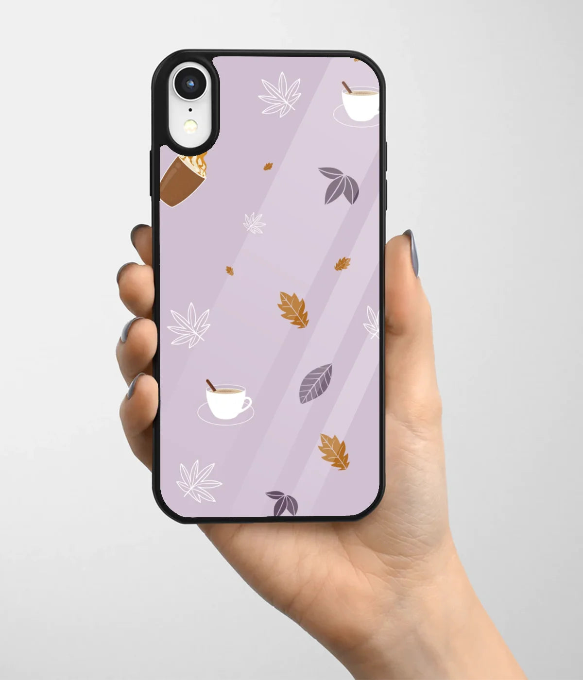 A hand holding a glass phone case with a colorful design.