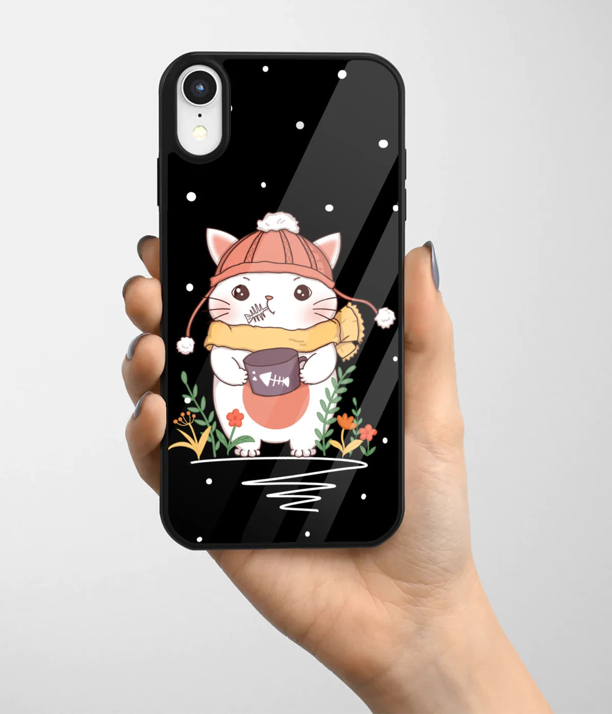 A hand holding a glass phone case with a colorful design.