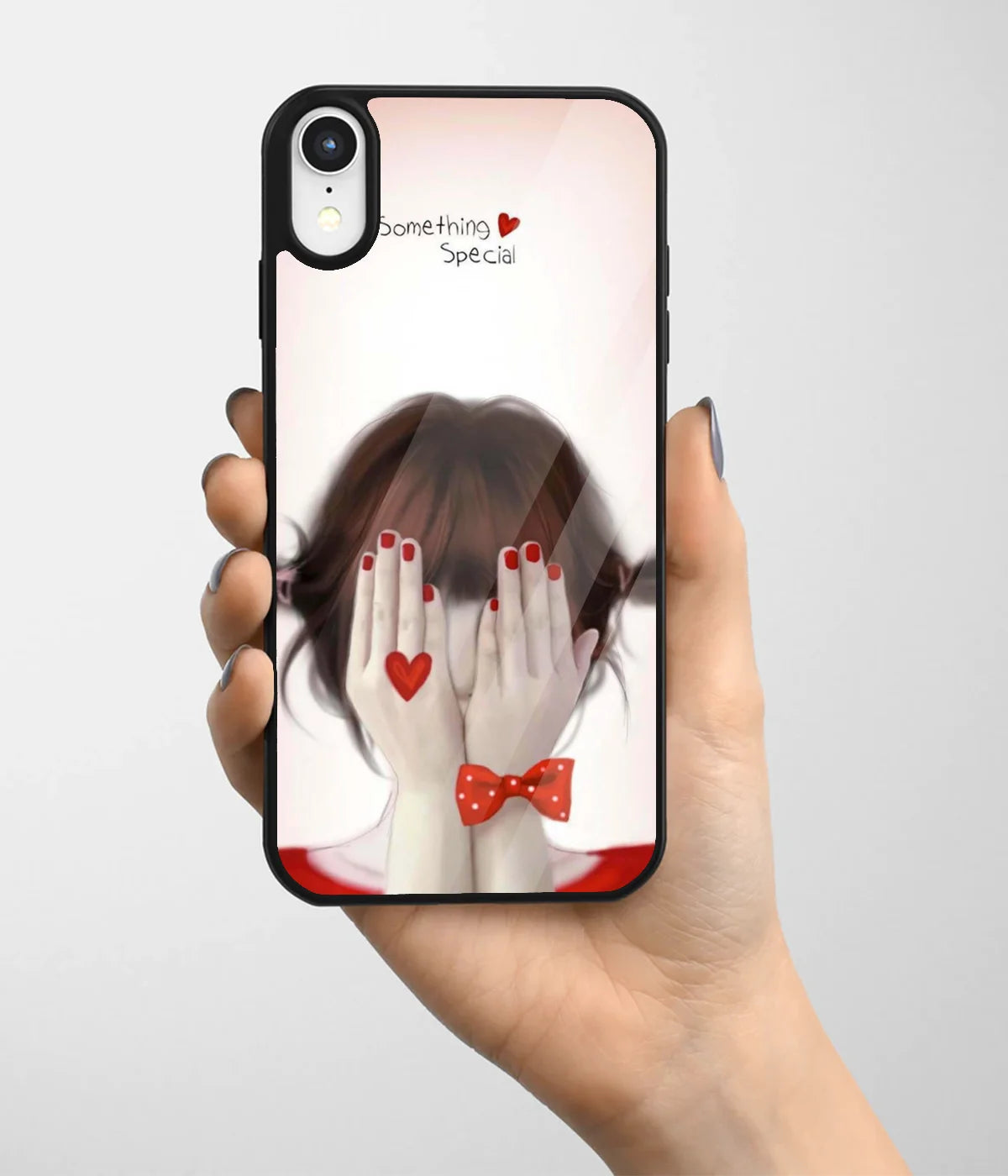A hand holding a glass phone case with a colorful design.