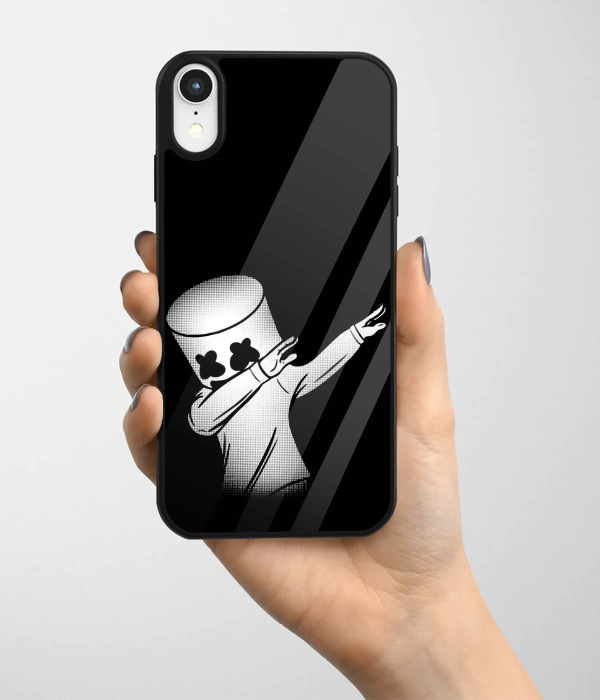 A hand holding a glass phone case with a colorful design.