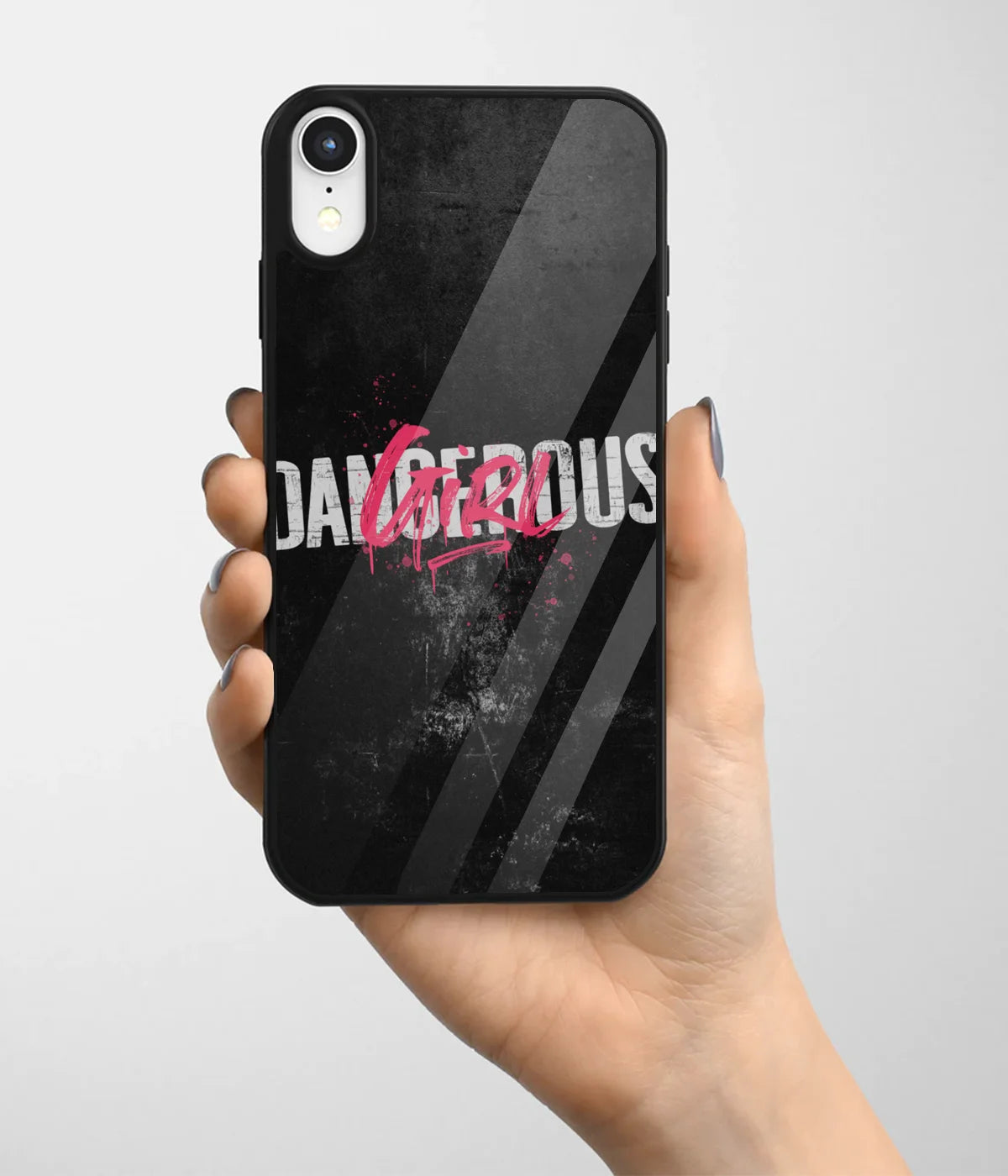 A hand holding a glass phone case with a colorful design.