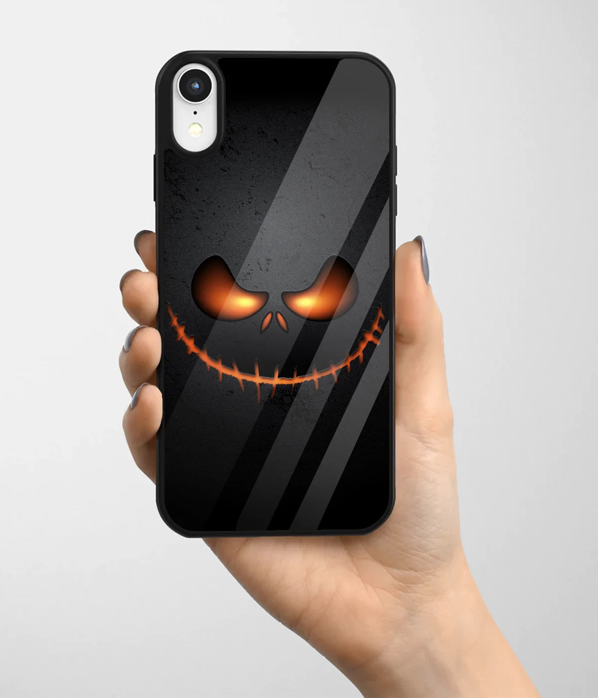 A hand holding a glass phone case with a colorful design.