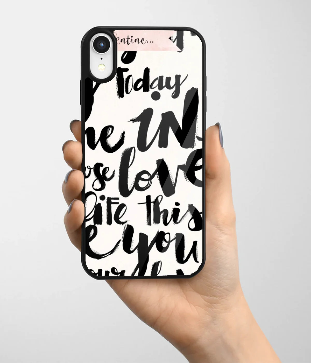 A hand holding a glass phone case with a colorful design.