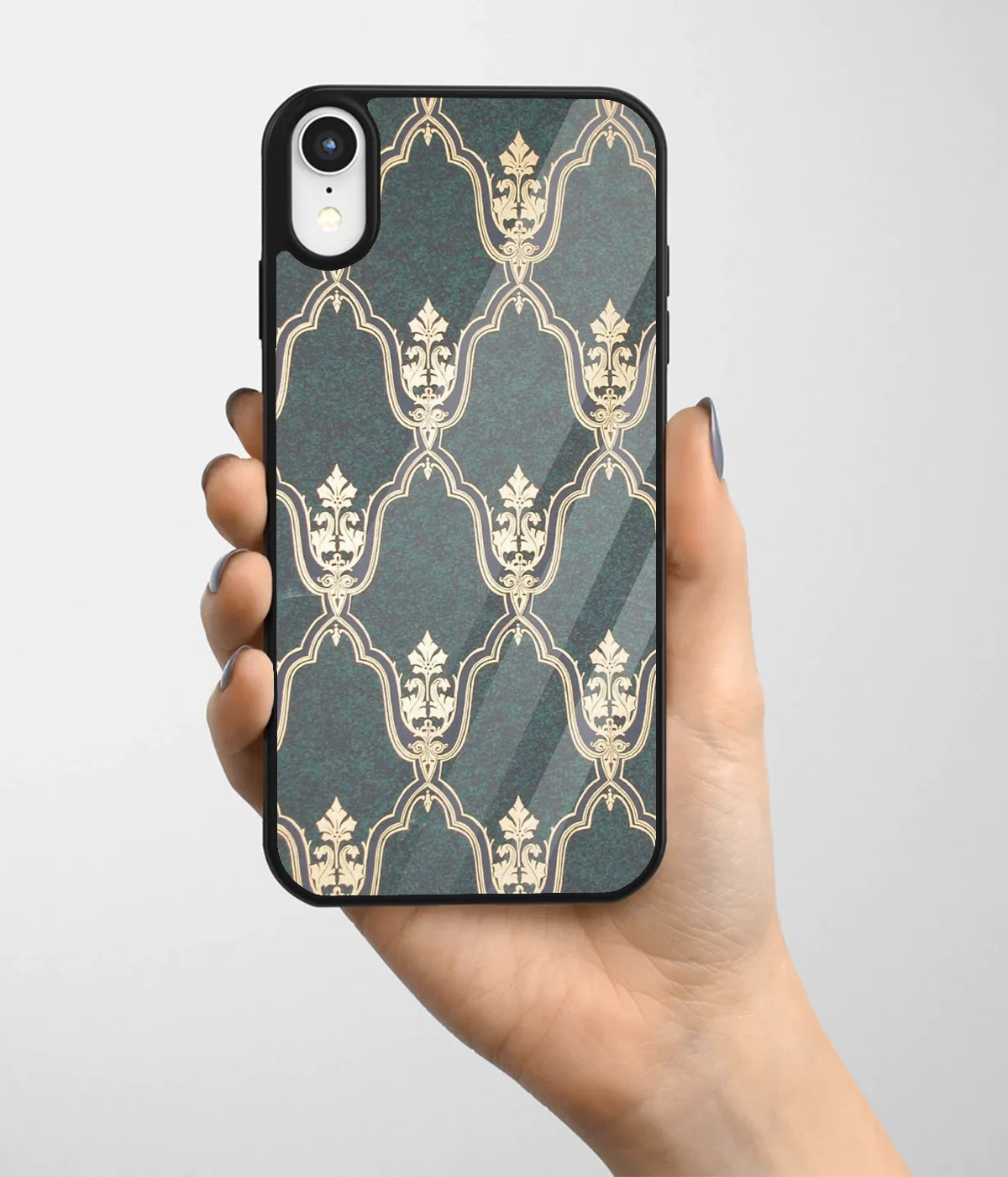 A hand holding a glass phone case with a colorful design.