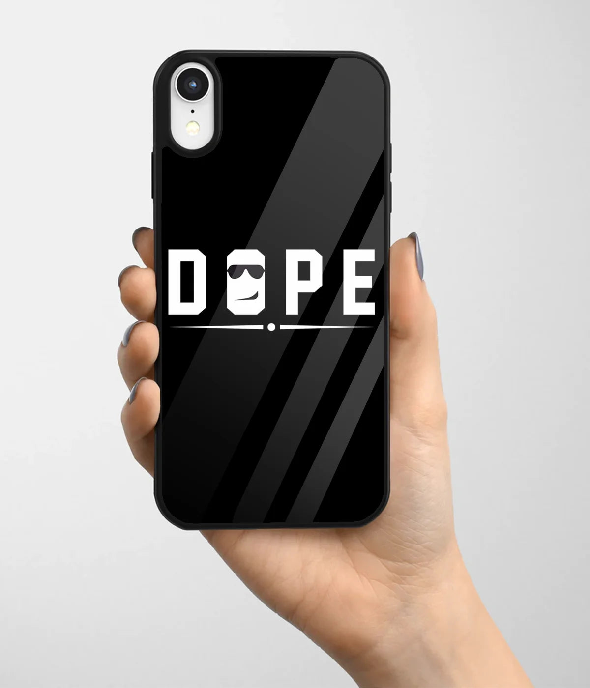 A hand holding a glass phone case with a colorful design.