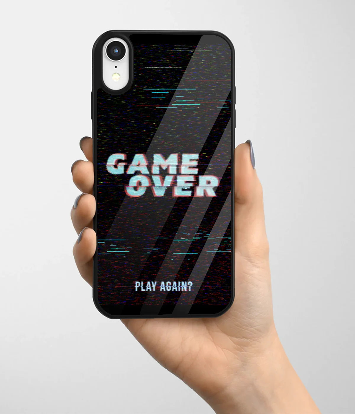 A hand holding a glass phone case with a colorful design.