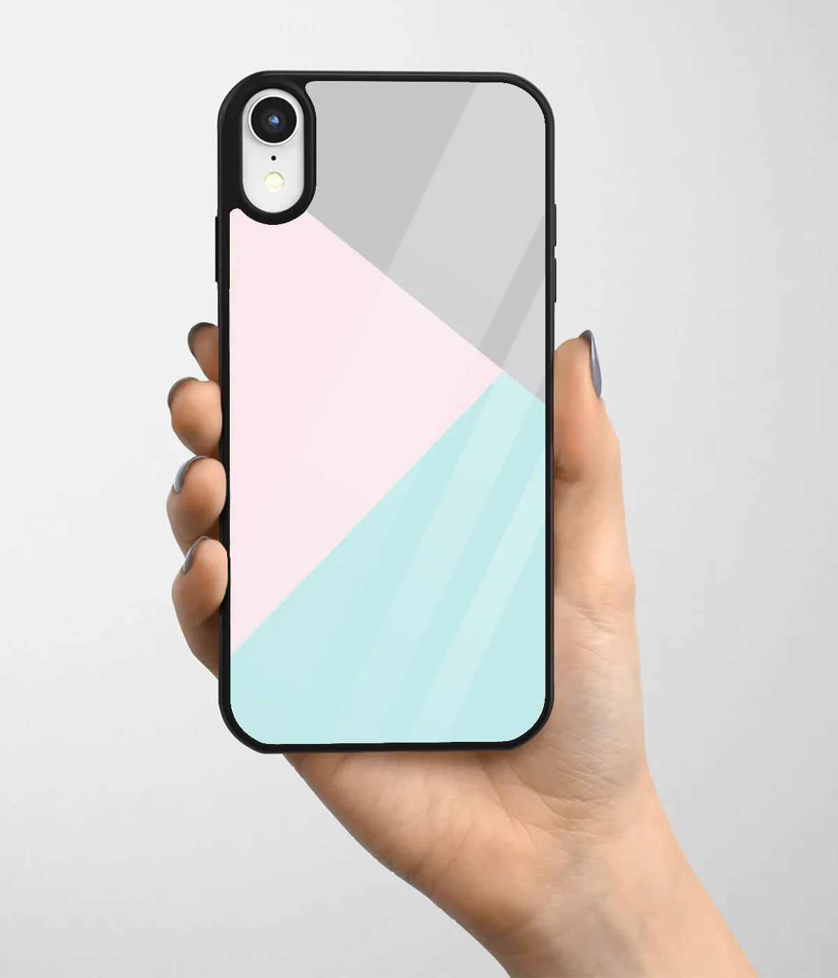 A hand holding a glass phone case with a colorful design.