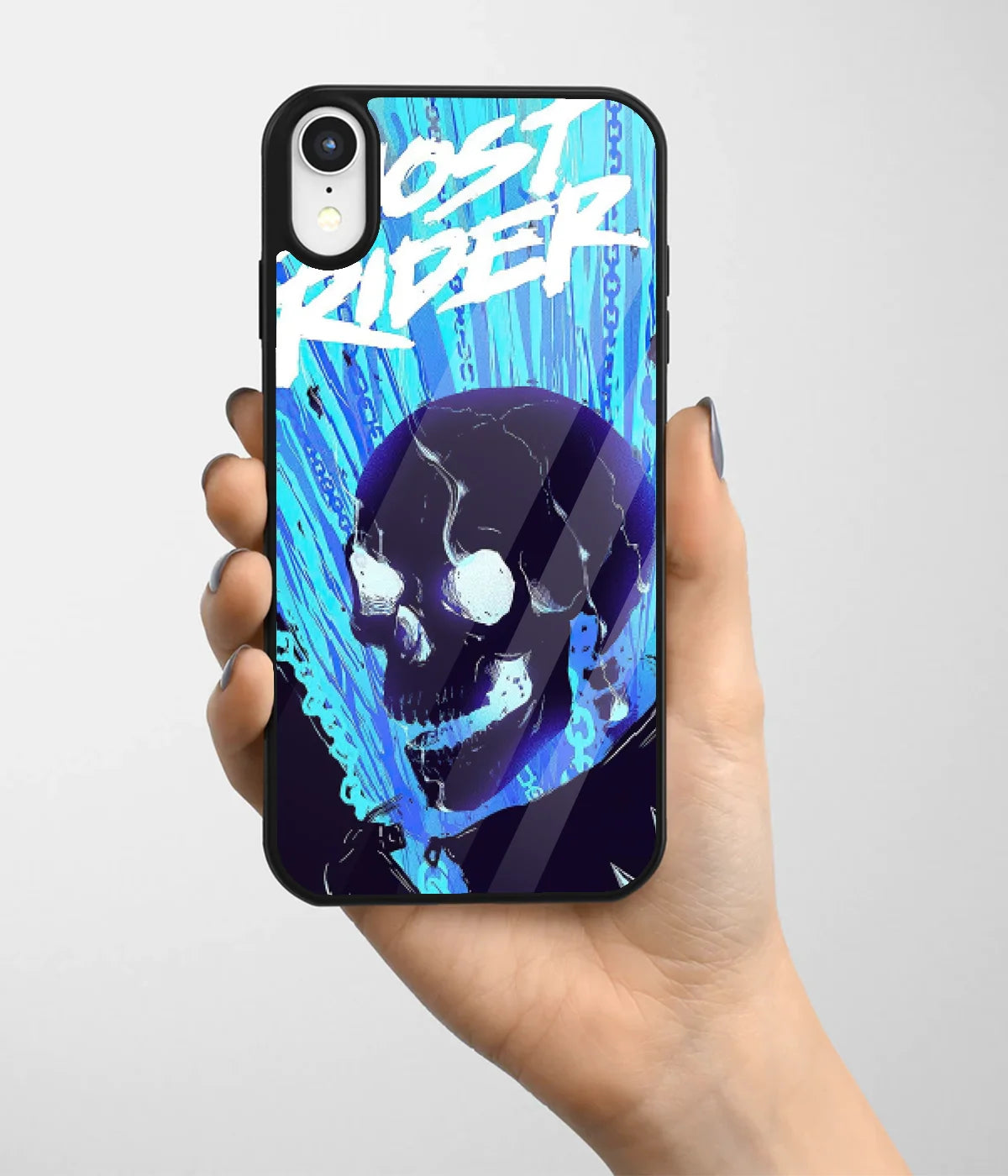 A hand holding a glass phone case with a colorful design.