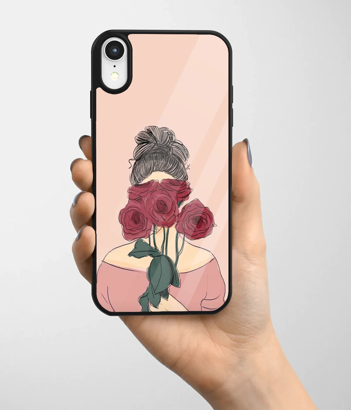 A hand holding a glass phone case with a colorful design.