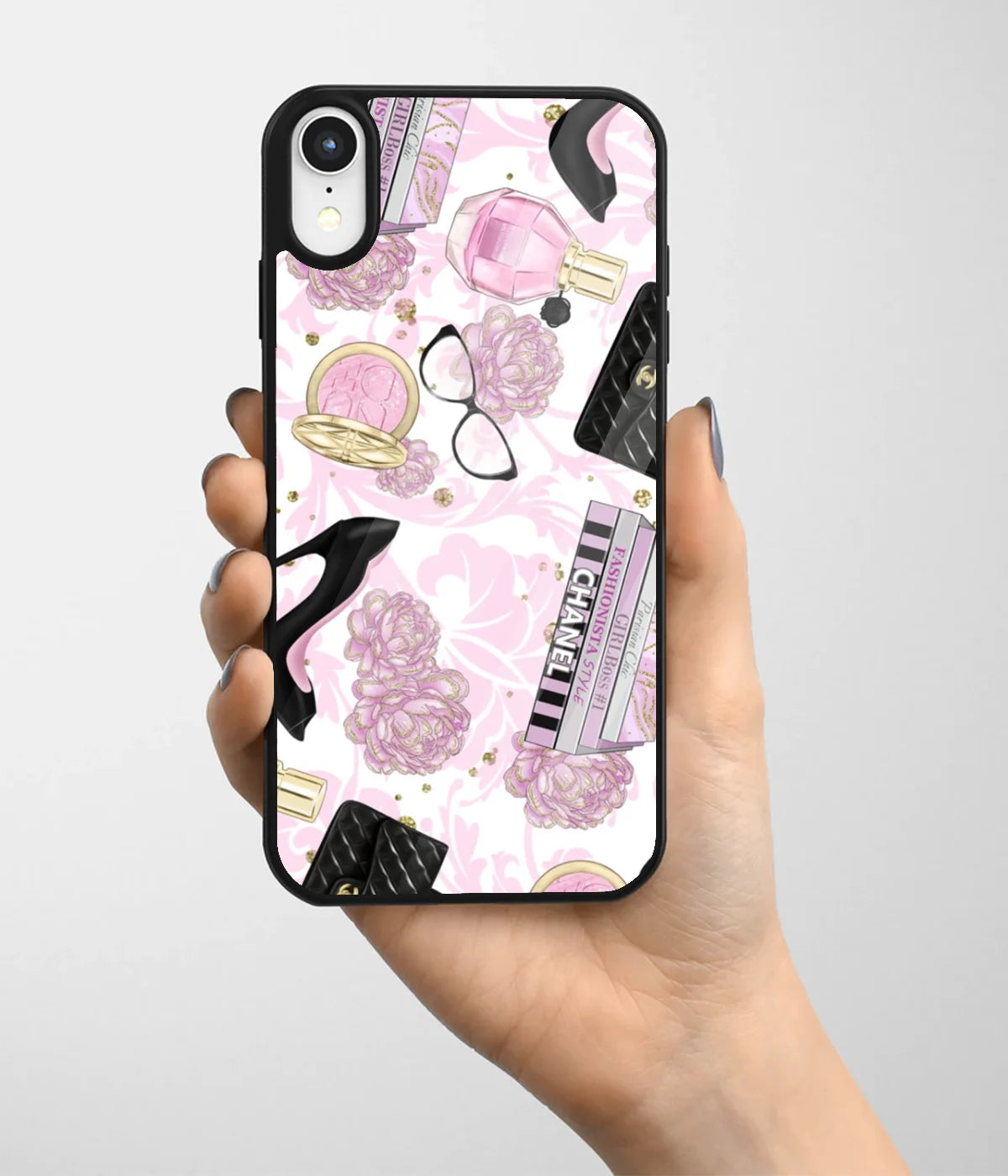 A hand holding a glass phone case with a colorful design.
