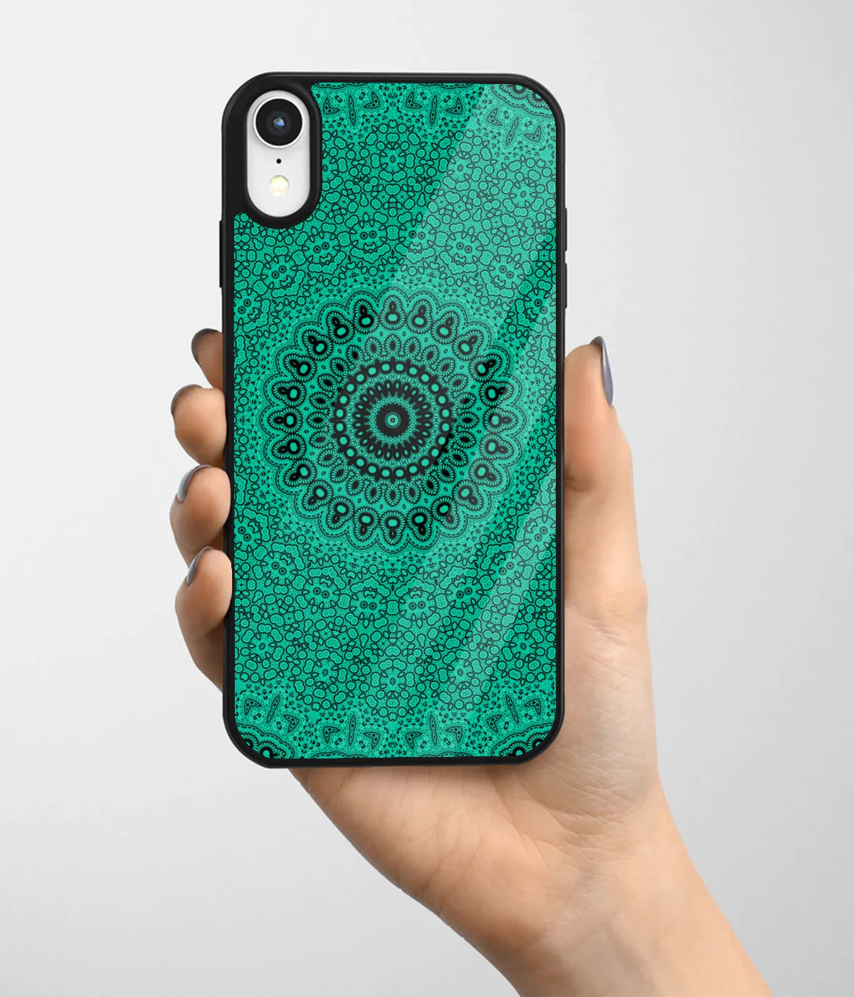 A hand holding a glass phone case with a colorful design.