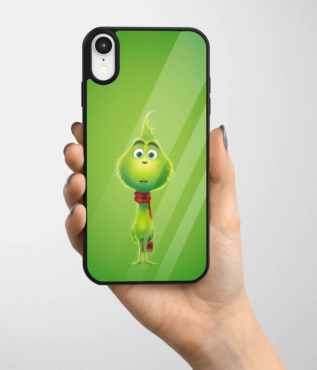 A hand holding a glass phone case with a colorful design.
