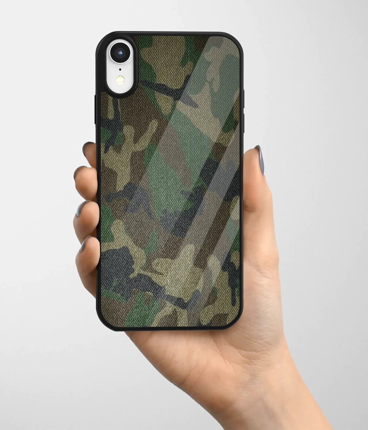 A hand holding a glass phone case with a colorful design.