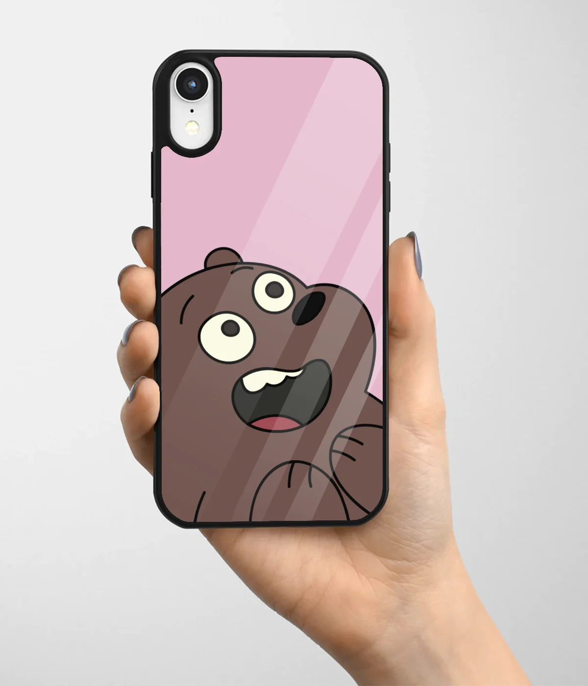 A hand holding a glass phone case with a colorful design.