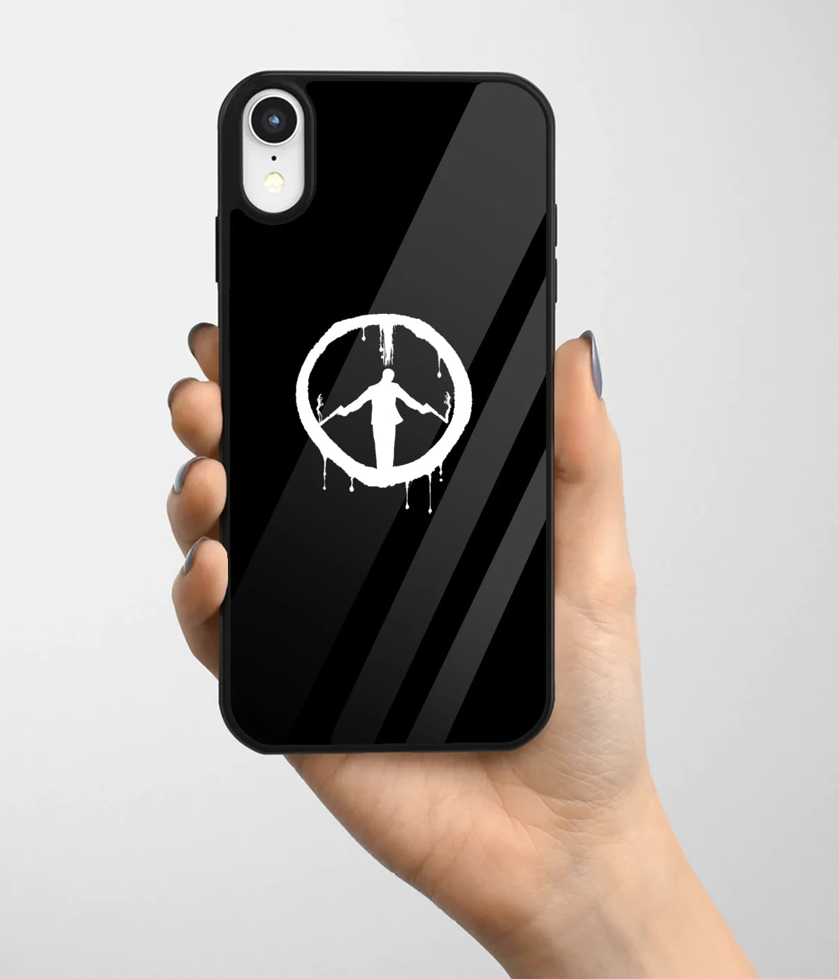 A hand holding a glass phone case with a colorful design.
