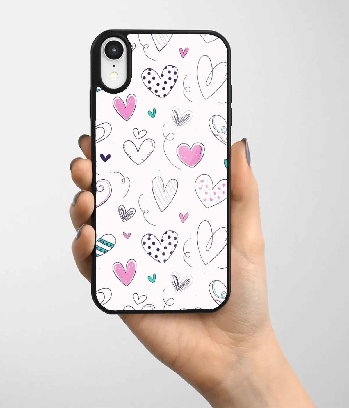 A hand holding a glass phone case with a colorful design.