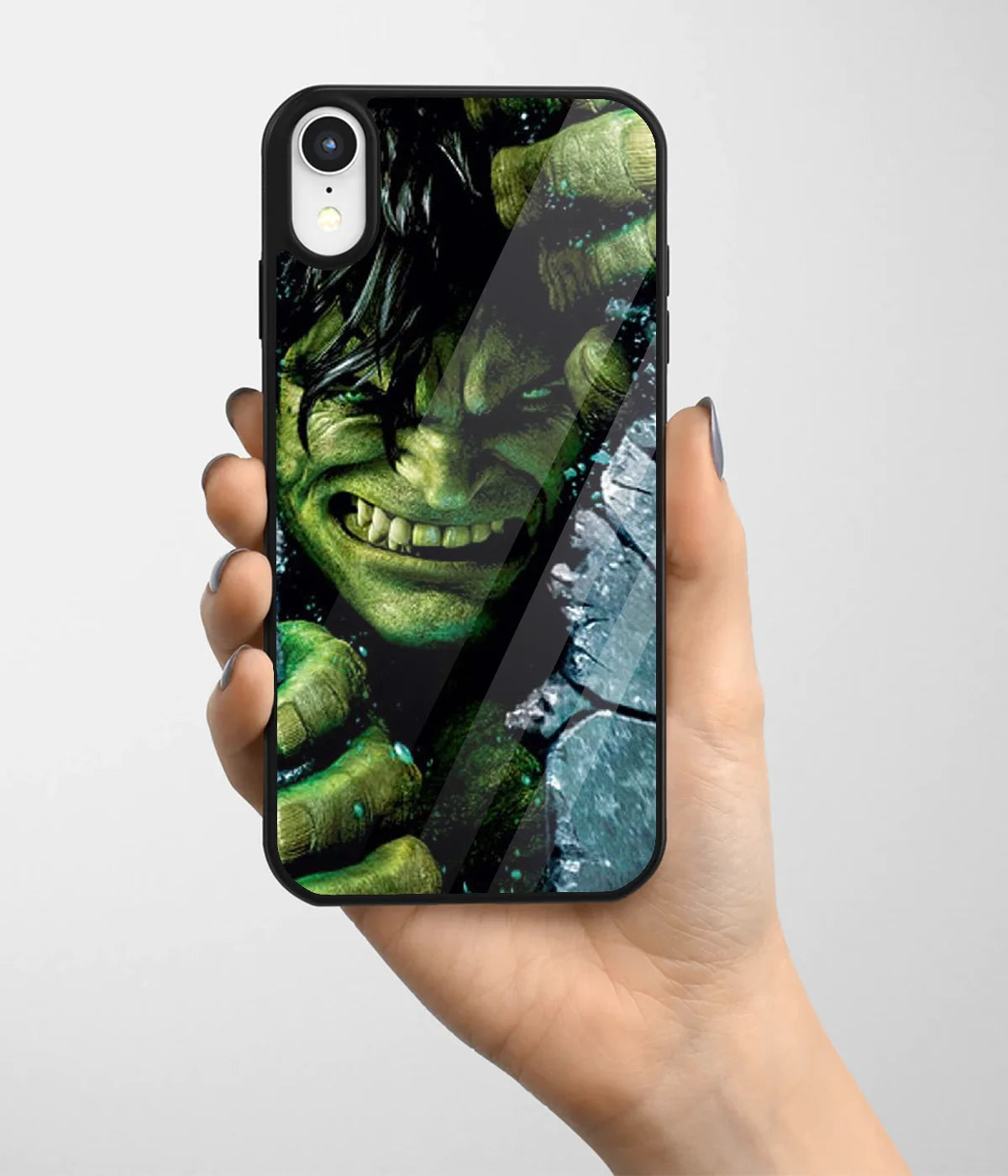 A hand holding a glass phone case with a colorful design.