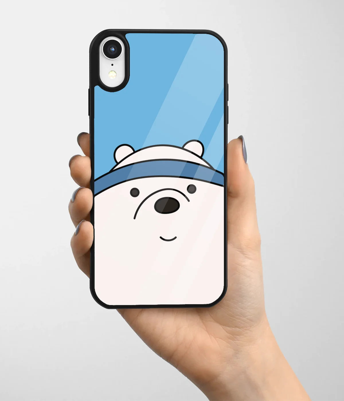 A hand holding a glass phone case with a colorful design.