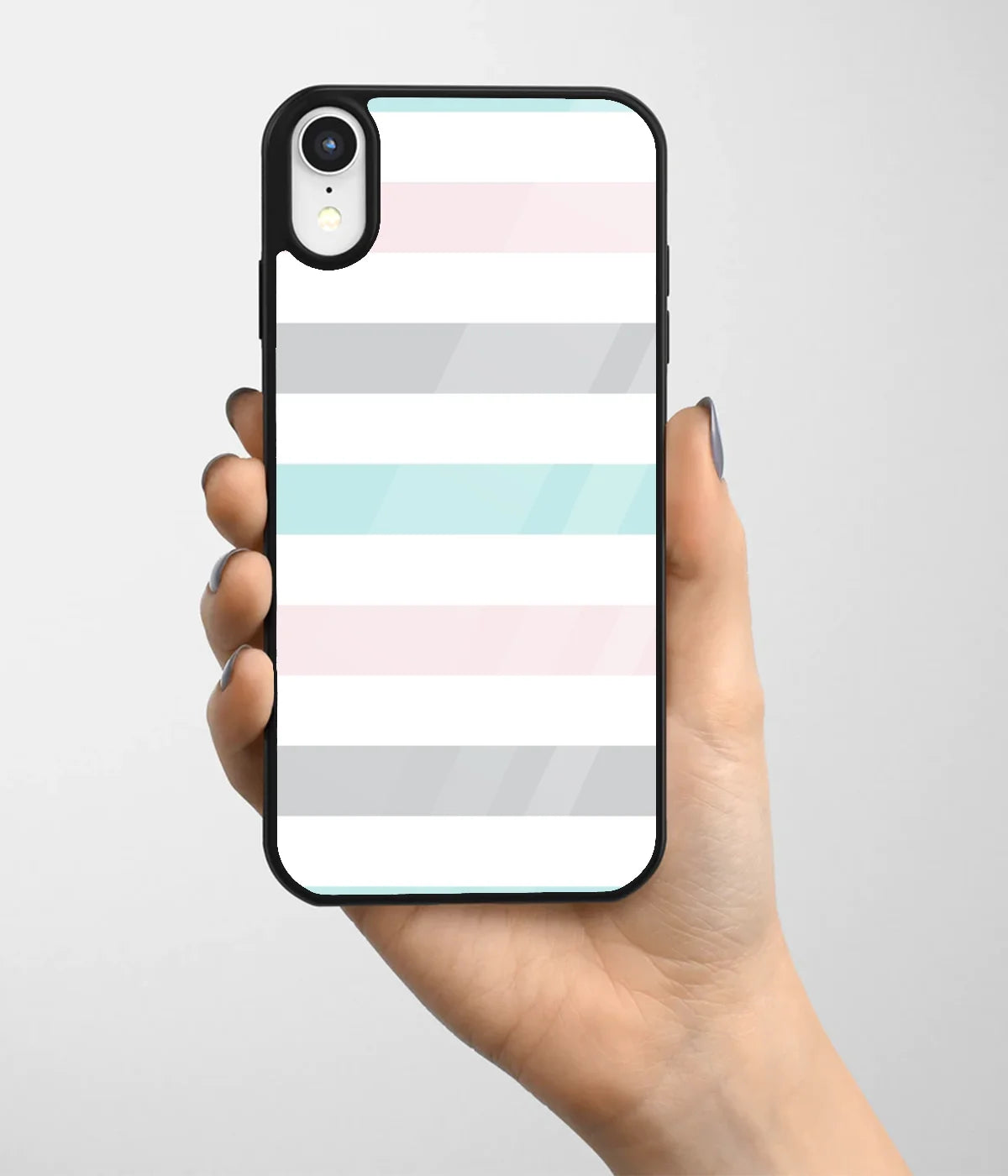A hand holding a glass phone case with a colorful design.
