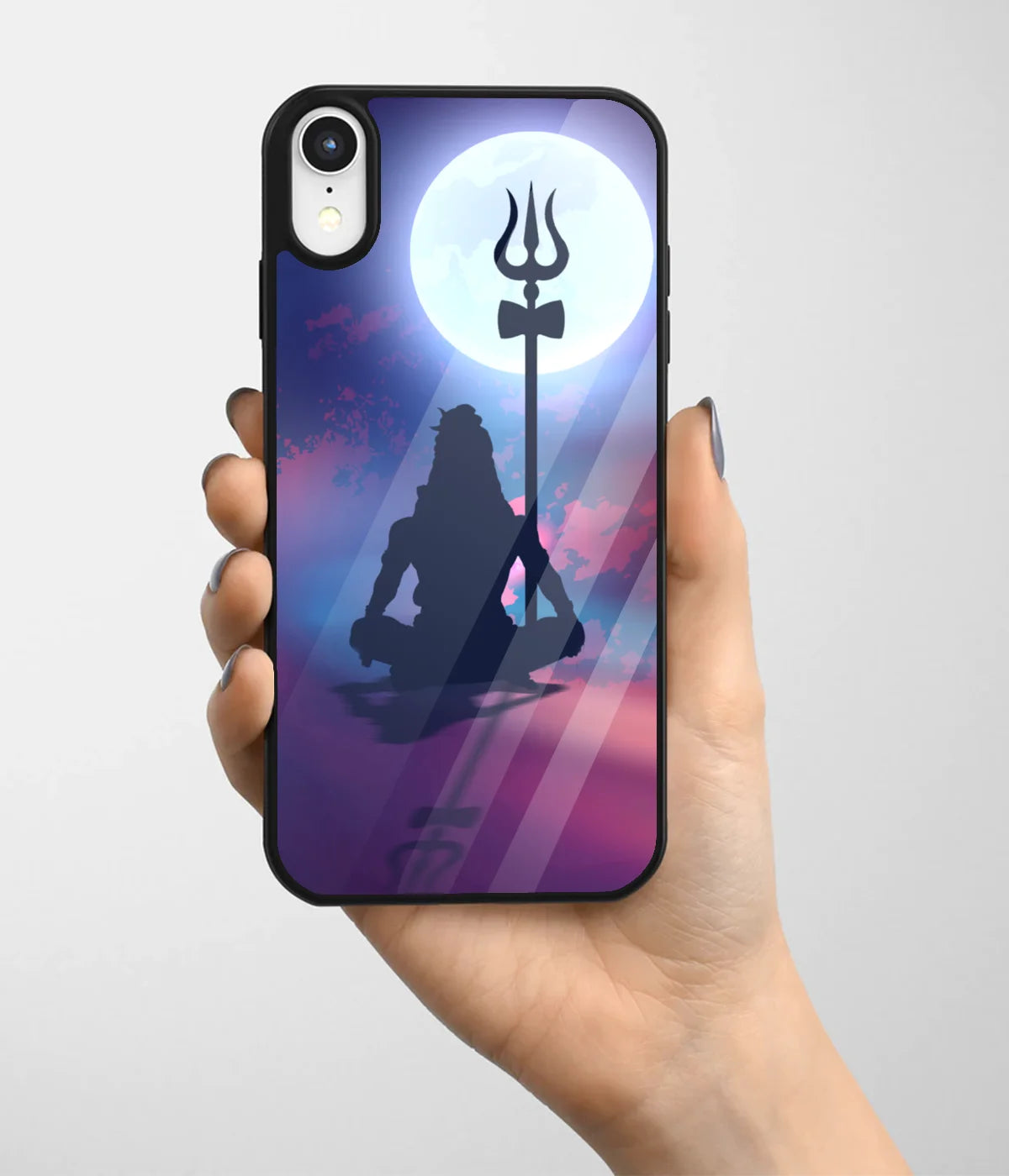 A hand holding a glass phone case with a colorful design.