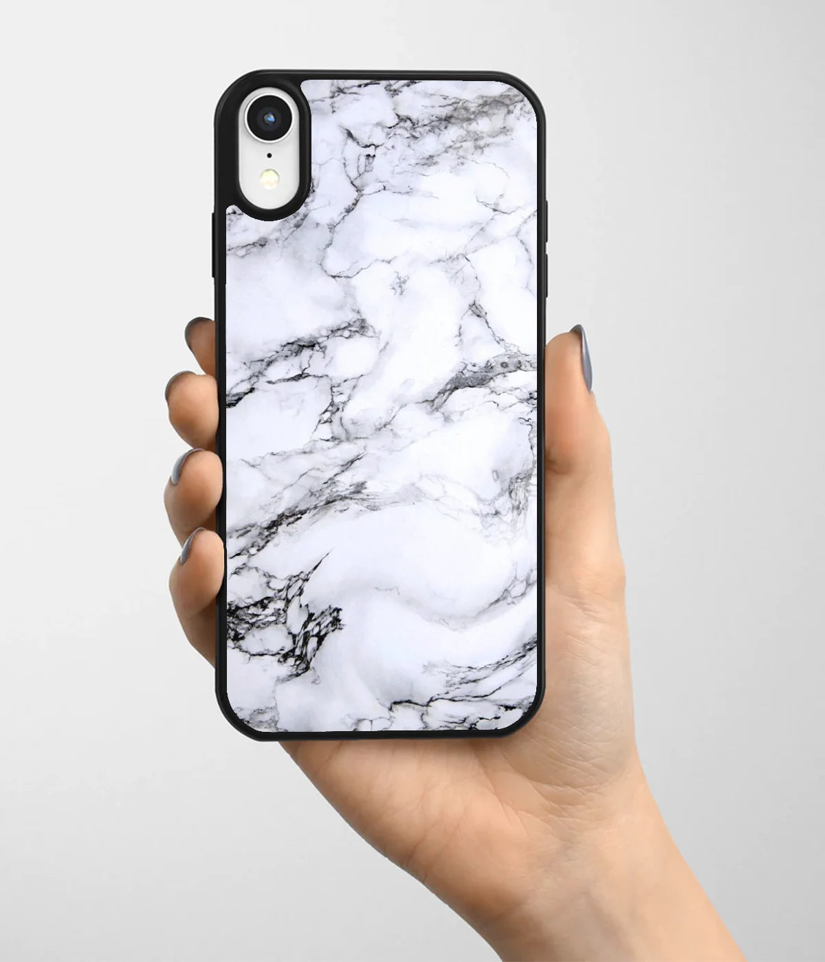 A hand holding a glass phone case with a colorful design.