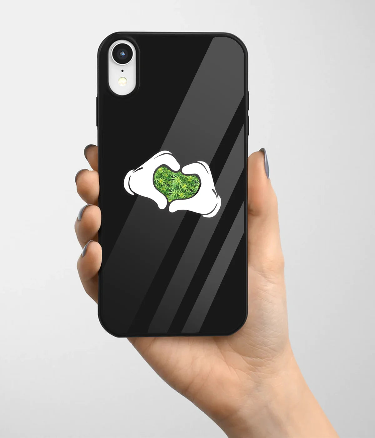 A hand holding a glass phone case with a colorful design.