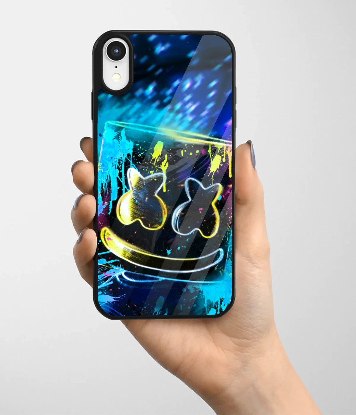 A hand holding a glass phone case with a colorful design.