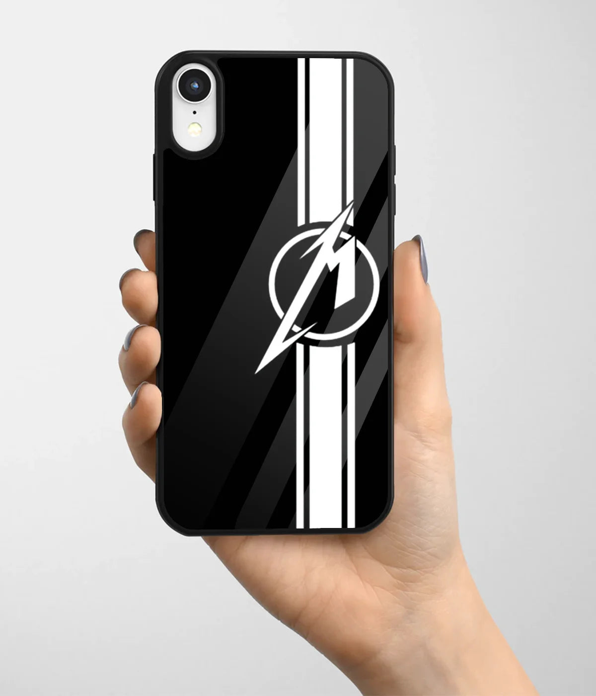 A hand holding a glass phone case with a colorful design.