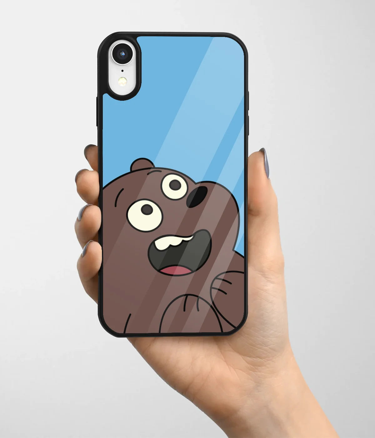 A hand holding a glass phone case with a colorful design.