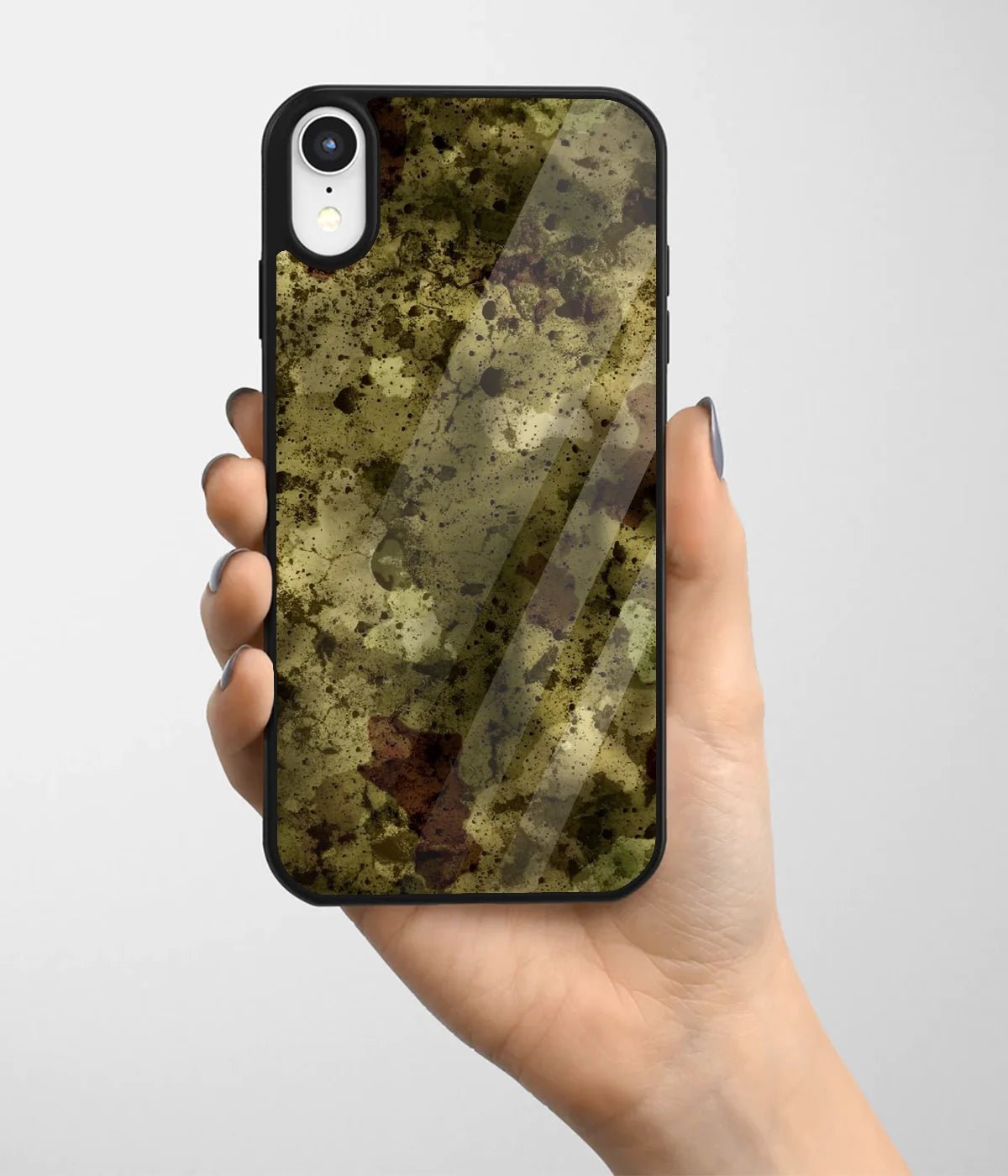 A hand holding a glass phone case with a colorful design.