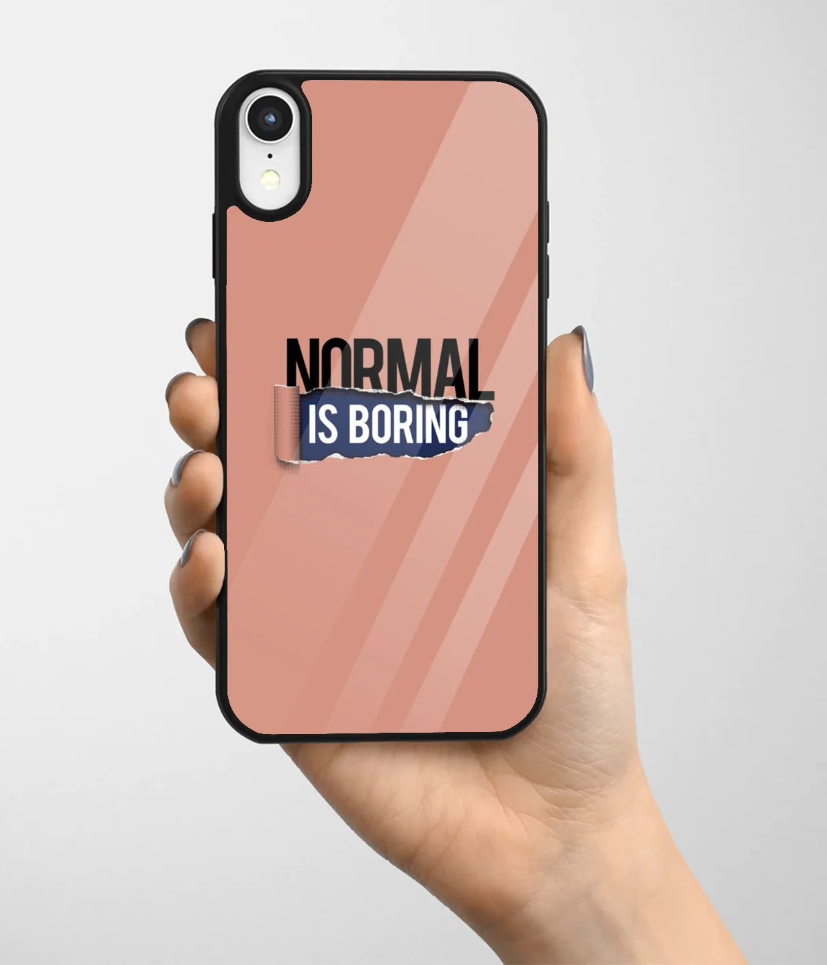 A hand holding a glass phone case with a colorful design.