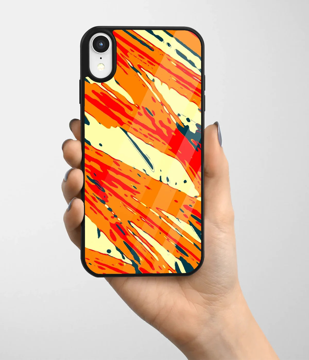 A hand holding a glass phone case with a colorful design.