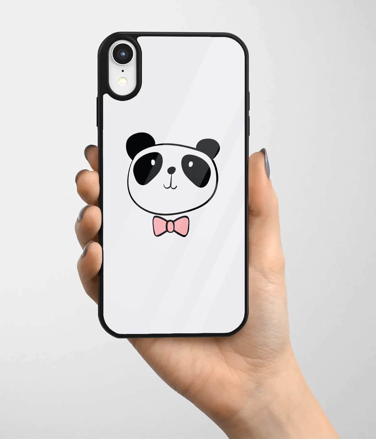 A hand holding a glass phone case with a colorful design.