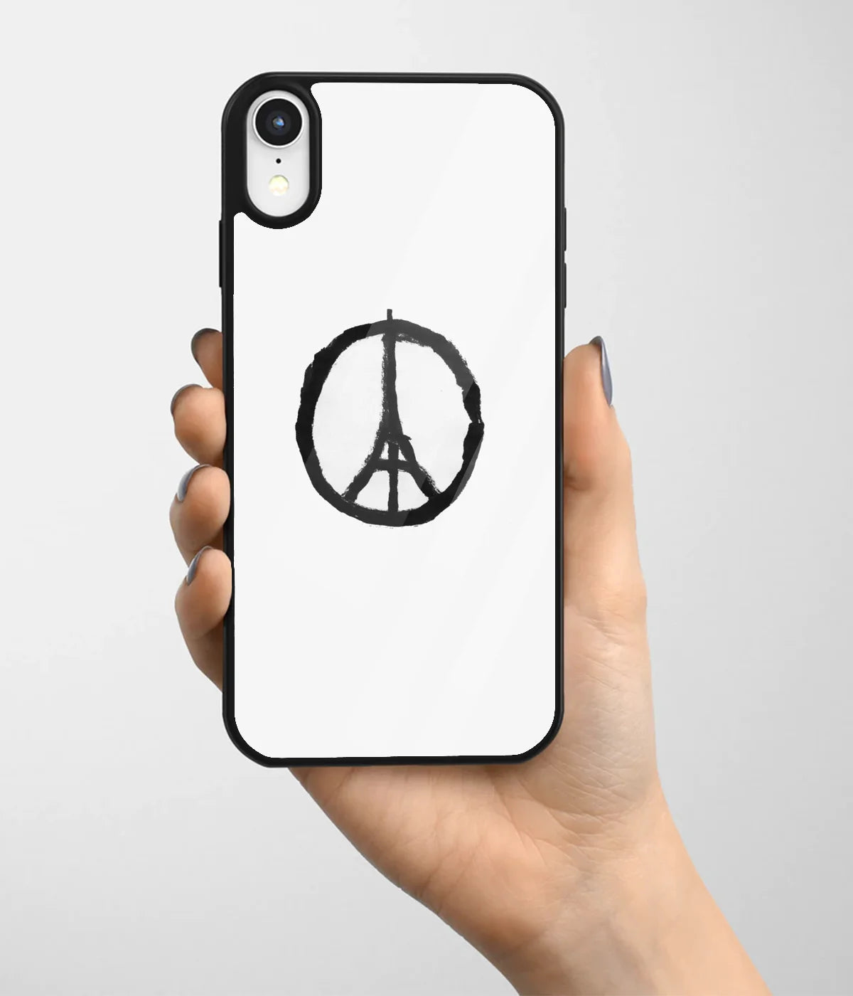 A hand holding a glass phone case with a colorful design.