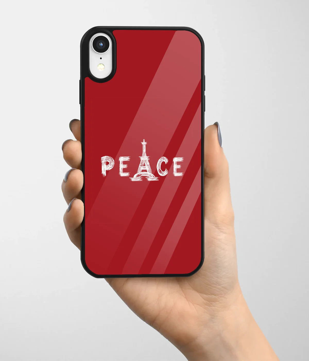 A hand holding a glass phone case with a colorful design.