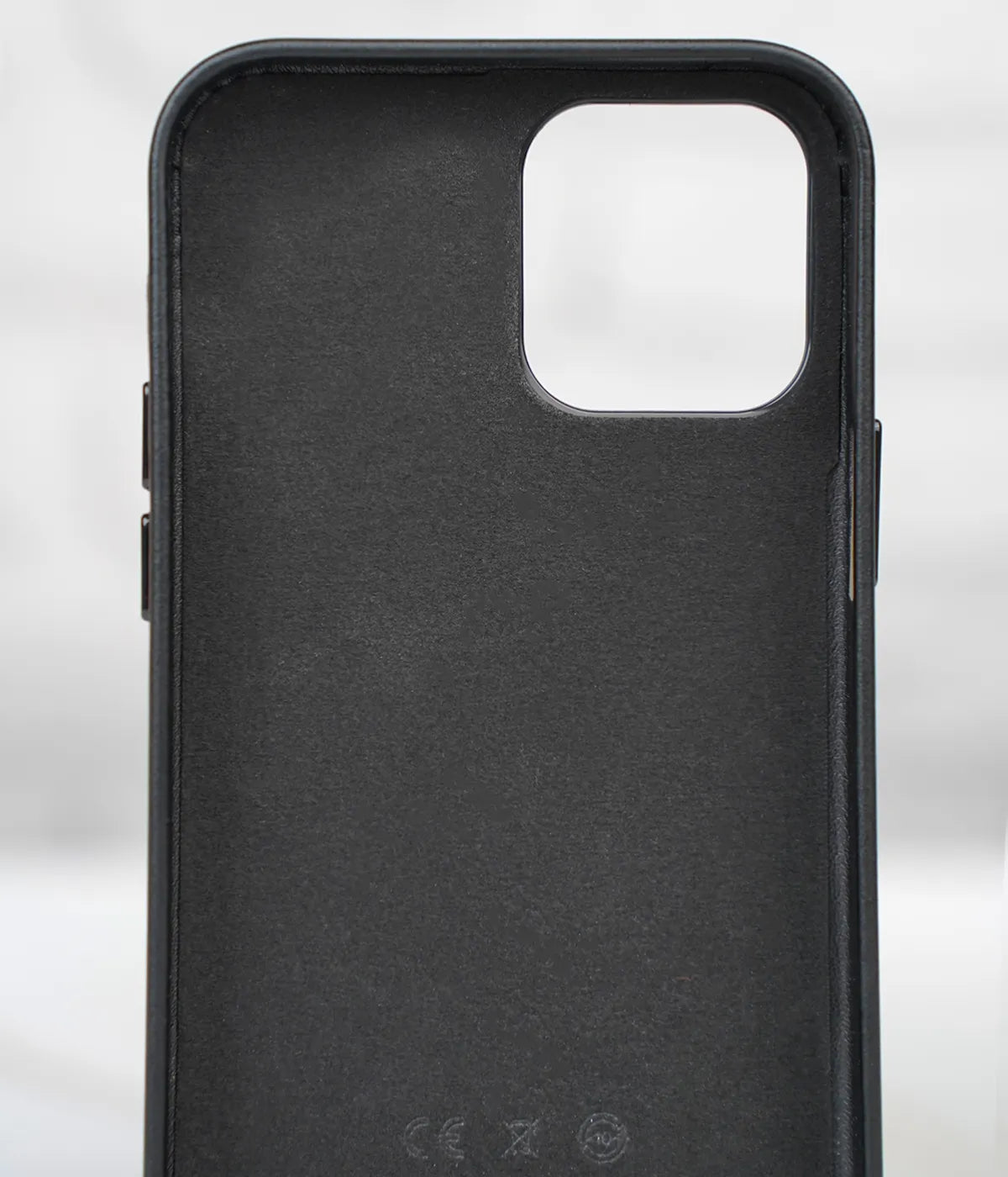 Inside view of the black premium leather iPhone case showing the soft interior lining designed to protect the back of the phone from scratches.