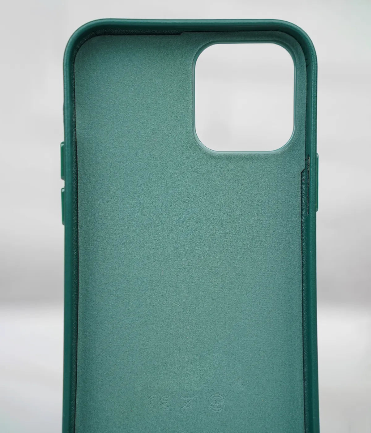 Inside view of the Cyprus Green premium leather iPhone case showing the soft interior lining designed to protect the back of the phone from scratches.