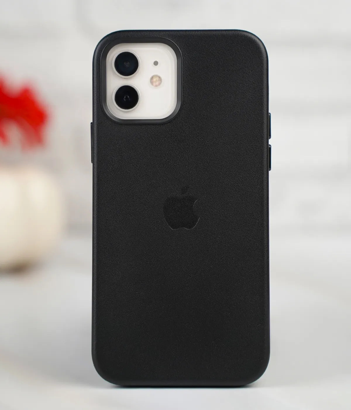Full back view of an iPhone protected by the premium black leather case, featuring a sleek design and an embossed Apple logo.
