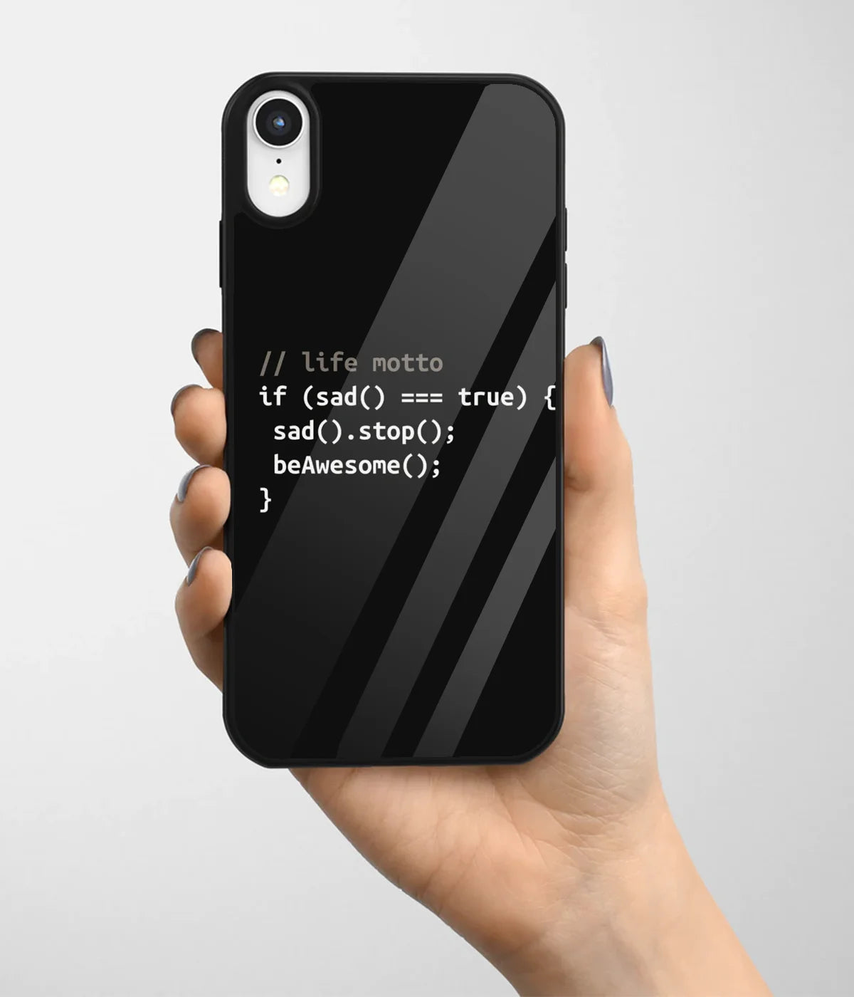 A hand holding a glass phone case with a colorful design.